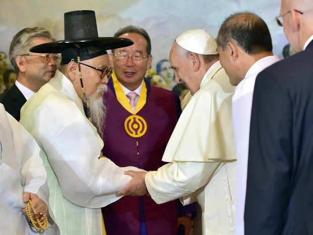 Pope Francis, third from right, talks with Han Yang-won, second from left, chairman of the Association for Korean Native Religion, as he meets with South Korea's religious leaders at Myeong-dong Cathedral in Seoul, South Korea, on Monday, Aug. 18, 2014. (AP Photo/Jung Yeon-je, Pool)