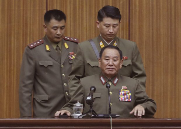 North Korea's General Reconnaissance Bureau Director Kim Yong Chol, bottom, takes his seat prior to the start of a briefing for foreign diplomats regarding the latest situation at the border between the two Koreas at the People's Cultural House in Pyongyang, North Korea, Friday, Aug. 21, 2015. North Korean leader Kim Jong Un on Friday declared his frontline troops in a "quasi-state of war" and ordered them to prepare for battle a day after the most serious confrontation between the rivals in years. (AP Photo/Dita Alangkara)
