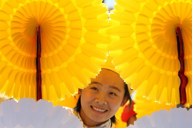 (091001) -- BEIJING, Oct. 1, 2009 (Xinhua) -- A student holds paper flowers while attending the celebrations for the 60th anniversary of the founding of the People's Republic of China, in central Beijing, capital of China, Oct. 1, 2009. (Xinhua/Hou Jun) (wh)
