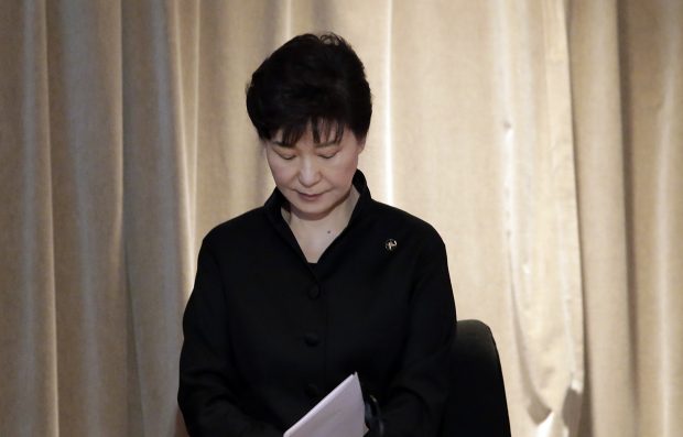 South Korea's President Park Geun-hye looks observes a minute of silence during a state funeral of the late Lee Kuan Yew, held at the University Cultural Center, Sunday, March 29, 2015, in Singapore. During a week of national mourning that began Monday after Lee's death at age 91, some 450,000 people queued for hours for a glimpse of Lee's coffin at Parliament House. A million people visited tribute sites at community centers across the island and leaders and dignitaries from more than two dozen countries attended the state funeral. (AP Photo/Wong Maye-E)