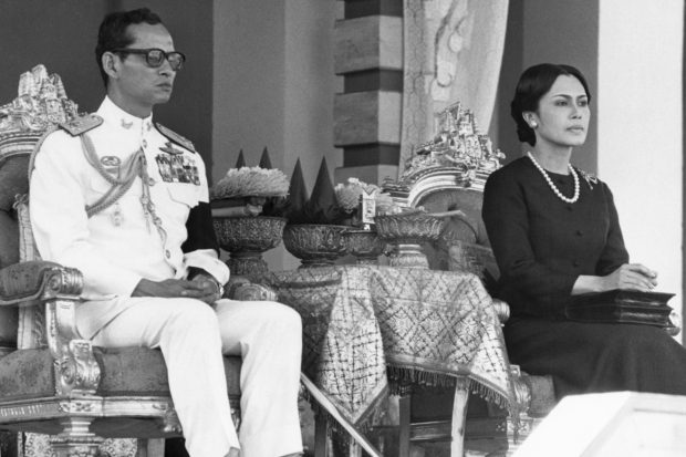 FILE - In this April 12, 1977, file photo, Thailand's King Bhumibol Adulyadej and Queen Sirikit attend a symbolic mass cremation ceremony for Thai soldiers and civilians killed by communist insurgents over a one year period. Thailand's Royal Palace said on Thursday, Oct. 13, 2016, that Thailand's King Bhumibol Adulyadej, the world's longest-reigning monarch, has died at age 88. (AP Photo/Neal Ulevich, File)